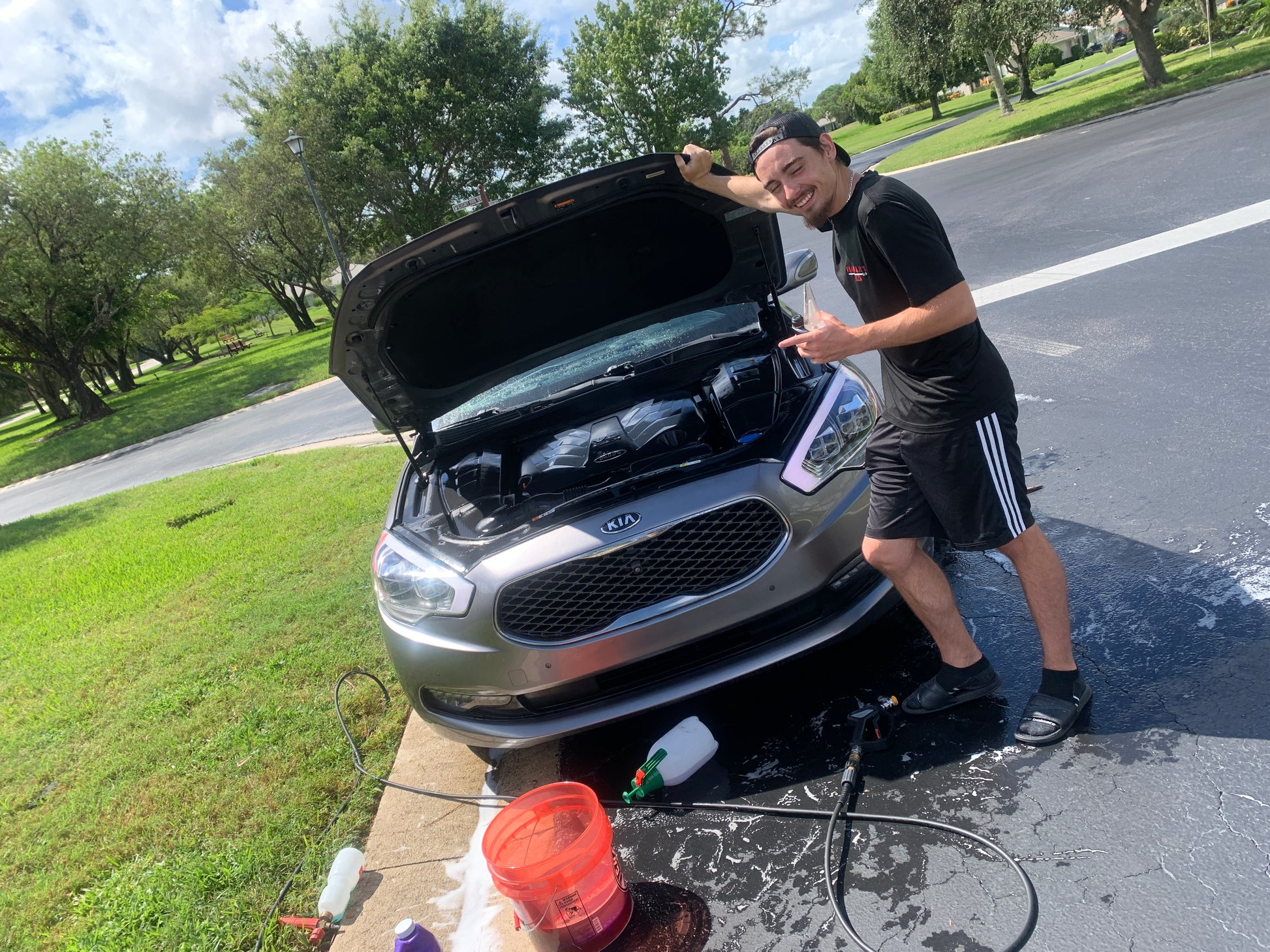 Happy client with a beaming smile next to their pristine vehicle.