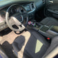 Interior of the blue Dodge Charger looking brand new, with a pristine dashboard, clean seats, and detailed surfaces.