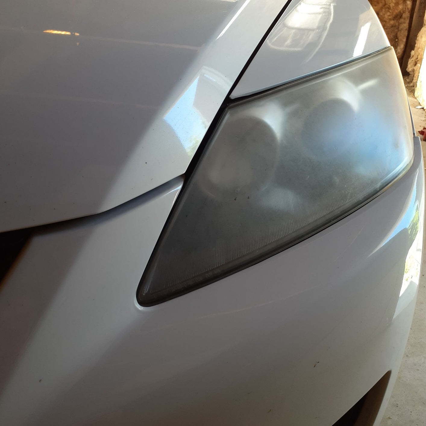 Close-up of oxidized headlights before being treated by our professional team 