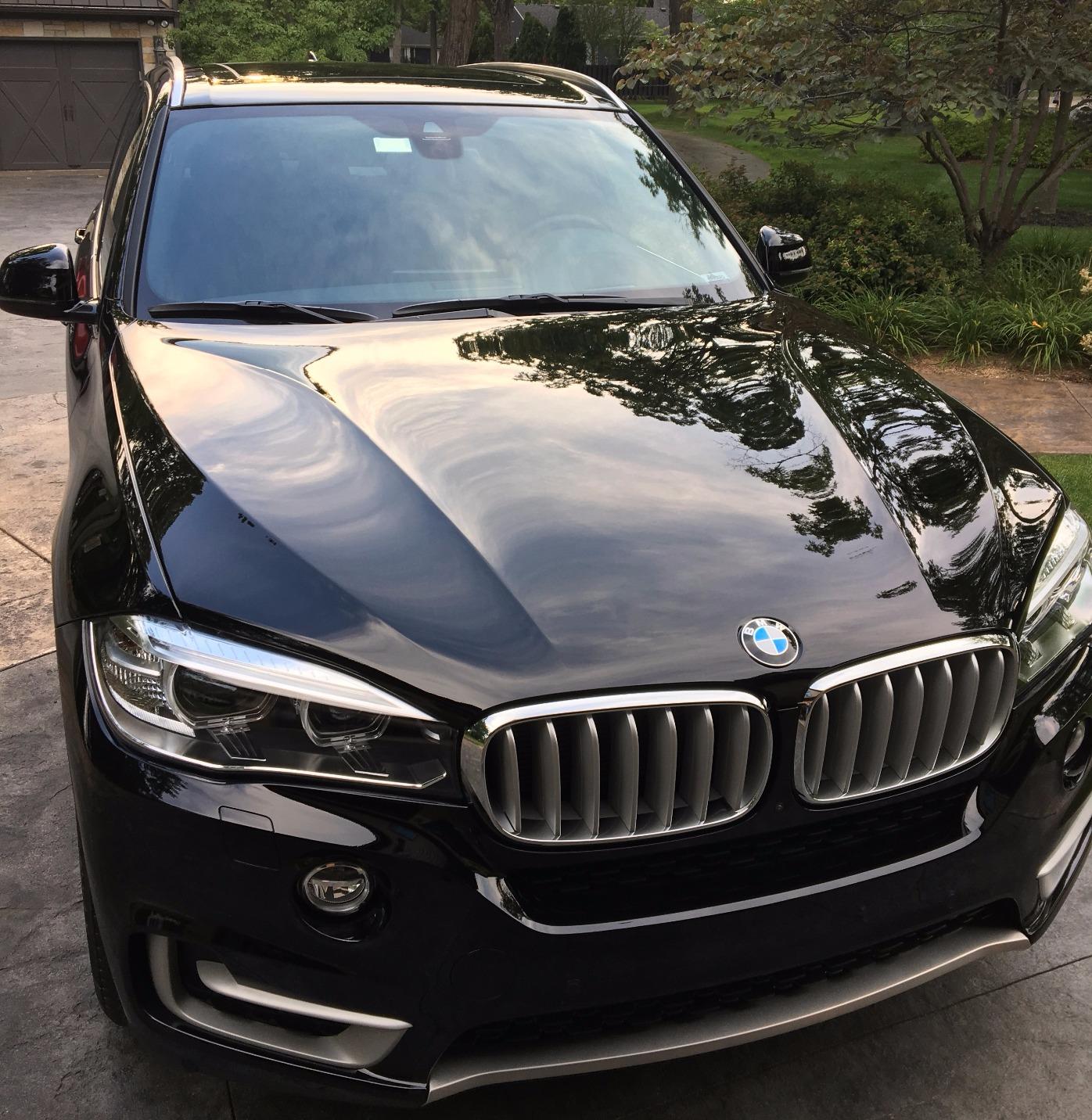 Detailer polishing the car's surface: Achieving a mirror-like finish.