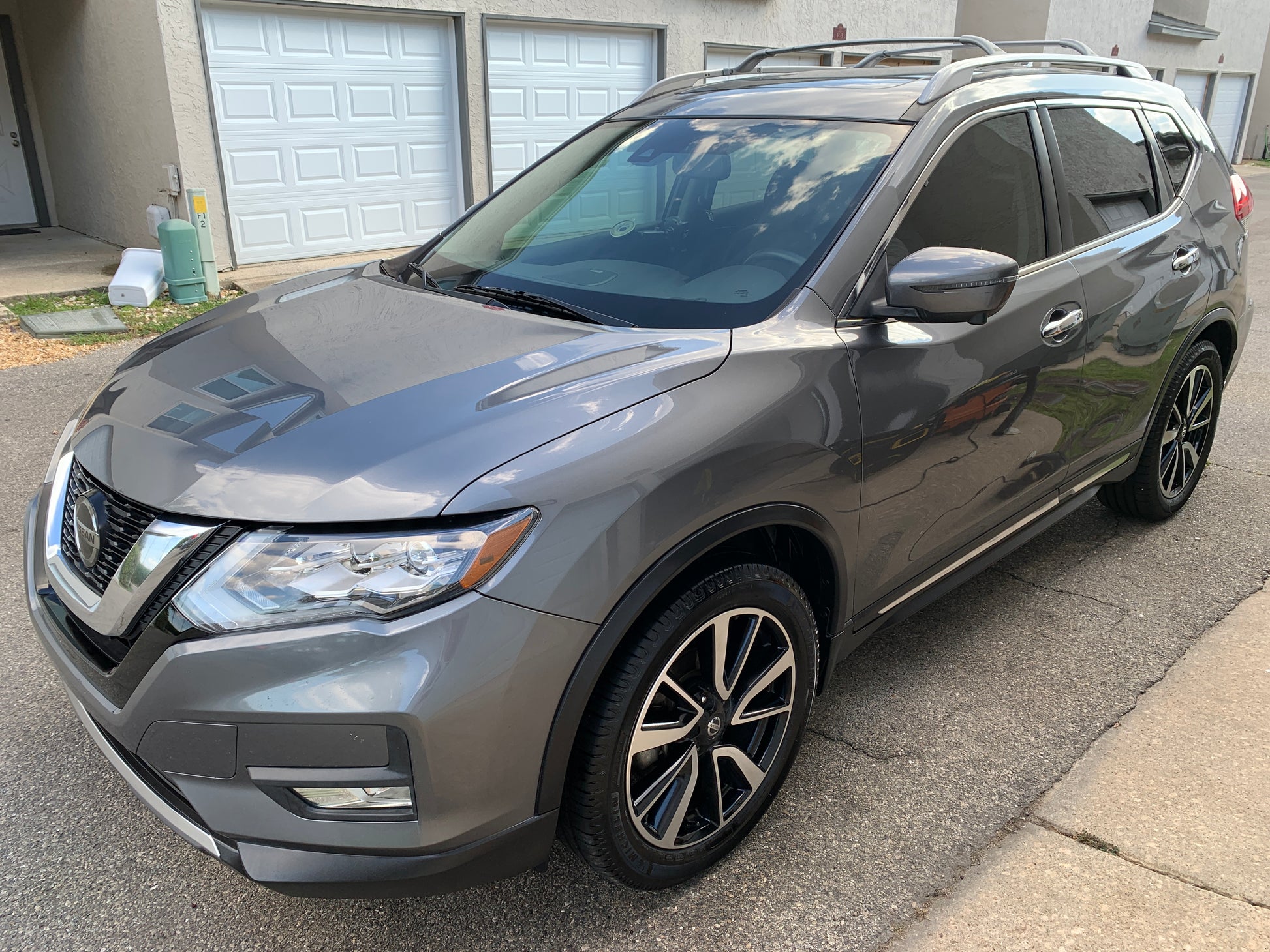 A car shining brilliantly under sunlight after receiving Finishline Detailing Garage's ceramic-coated wax treatment, highlighting a sleek and polished finish.