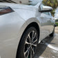 Low-angle view of a sleek, detailed vehicle, capturing its polished side profile and front wheel