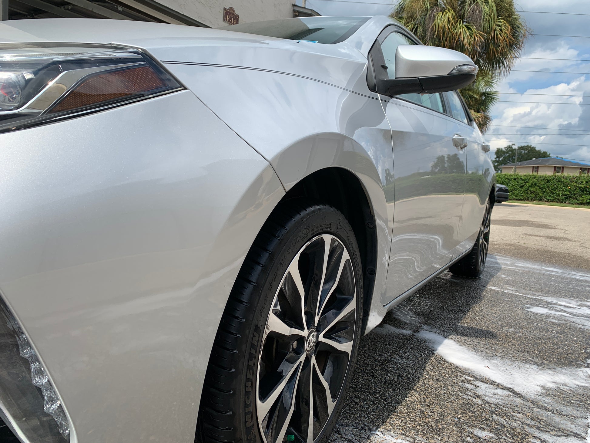 Low-angle view of a sleek, detailed vehicle, capturing its polished side profile and front wheel