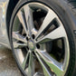 Close-up shot of a shiny, detailed wheel with a protective ceramic coating applied, showcasing its brand-new appearance."